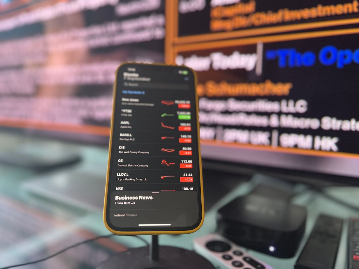 Smartphone showing live stock market updates