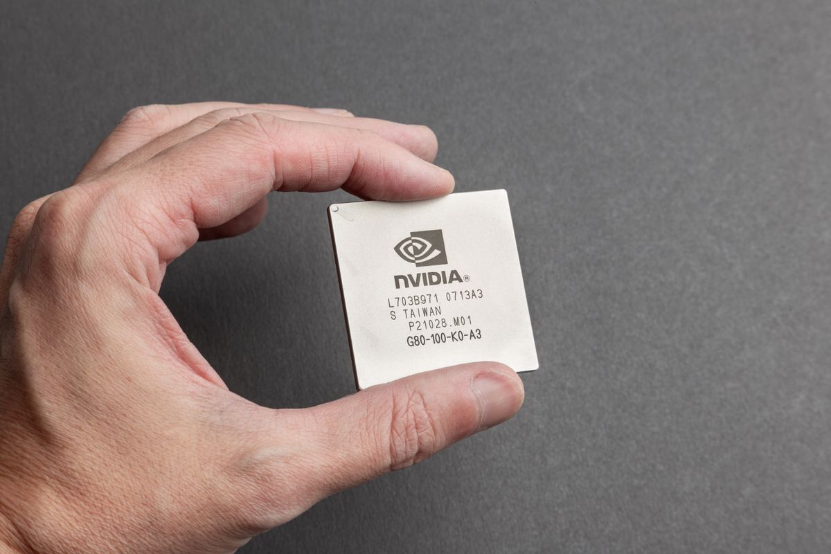 Close-up of an Nvidia chip held between fingers