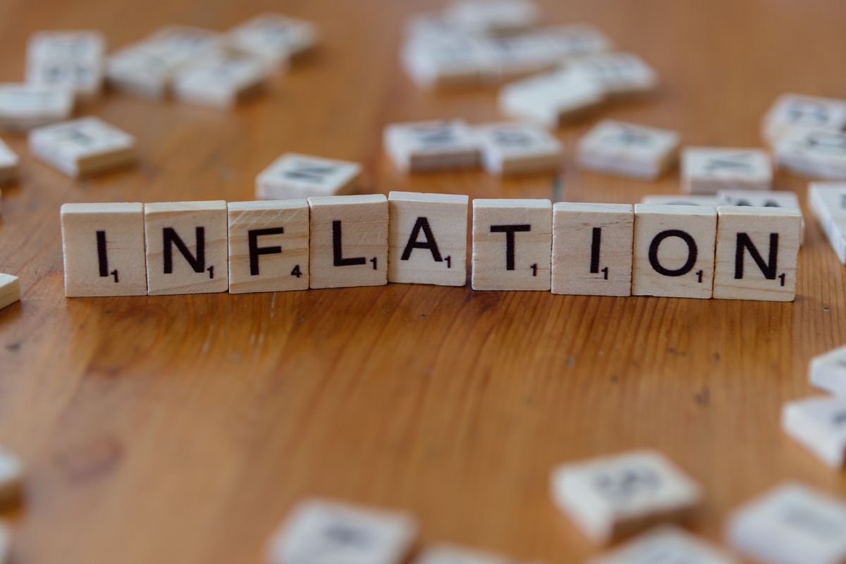 Scrabble tiles spelling the word INFLATION on a wooden surface