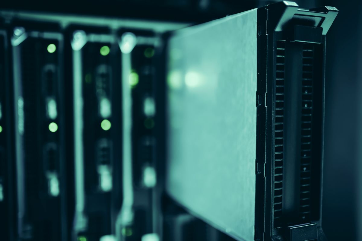 Server racks in a modern data centre with blue lighting