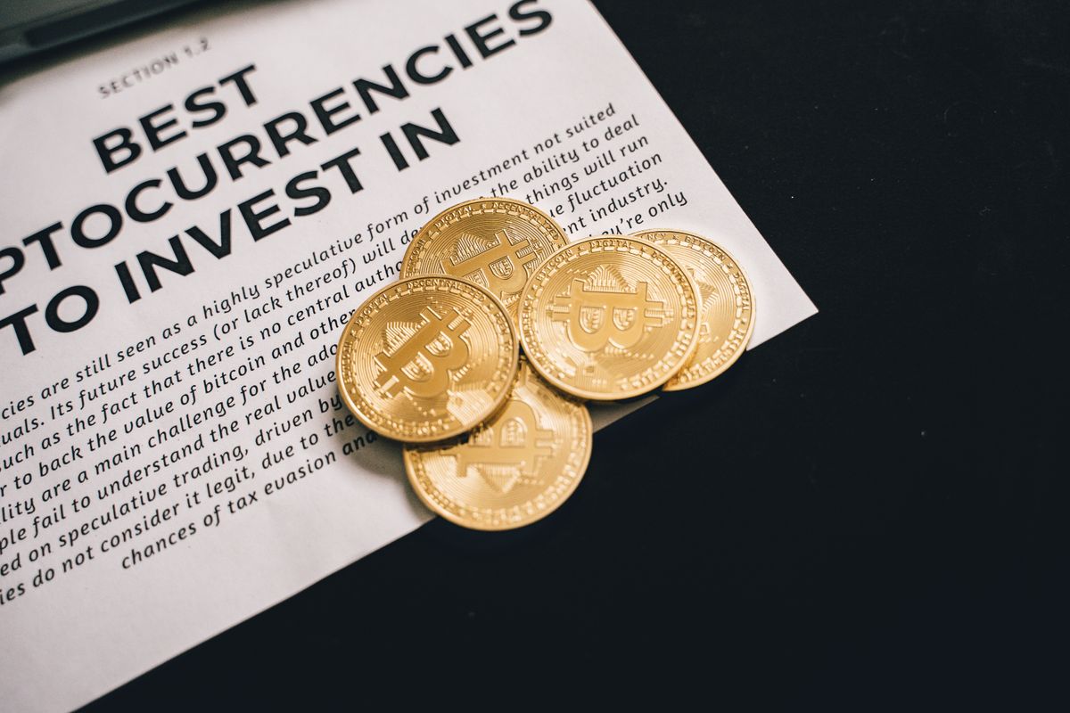 Bitcoin coins on an investment document